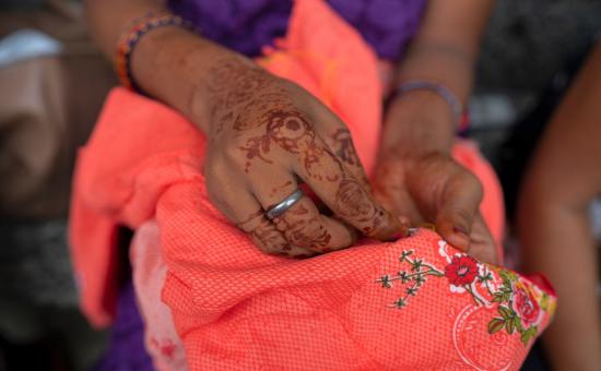 A woman's hands embroidering some cloth